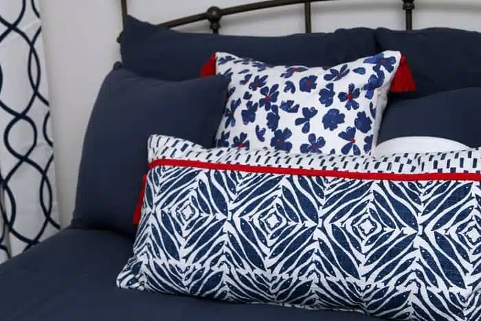 blue bedroom with red white and blue pillows