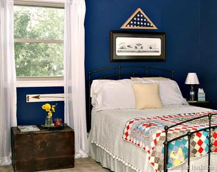 blue bedroom with antique wood trunk nightstand