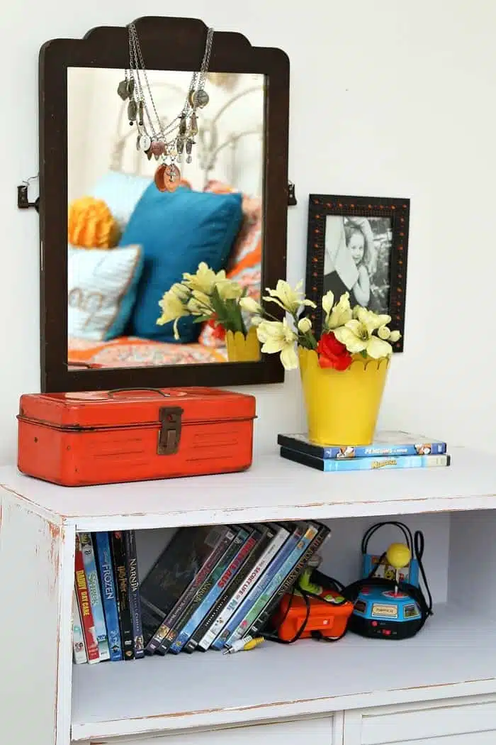 decorate a room with mirrors and framed photographs