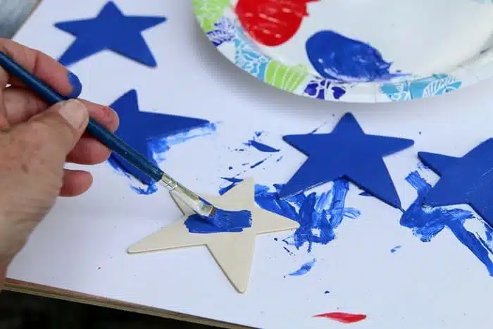 painting blue stars for red white and blue diy project