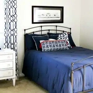 white bedroom walls and navy bedding for bedroom makeover 1
