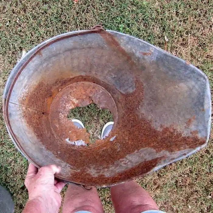 galvanized coal skuttle with a rustied out bottom