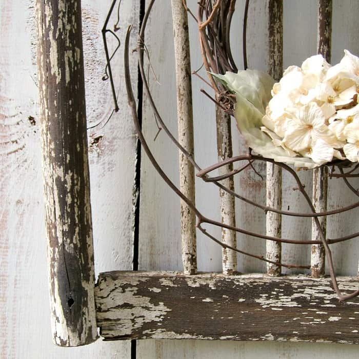 Old shabby wood chair back makes a great backdrop for a wreath