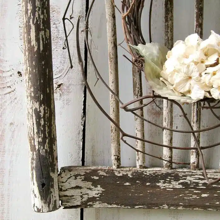 Old shabby wood chair back makes a great backdrop for a wreath