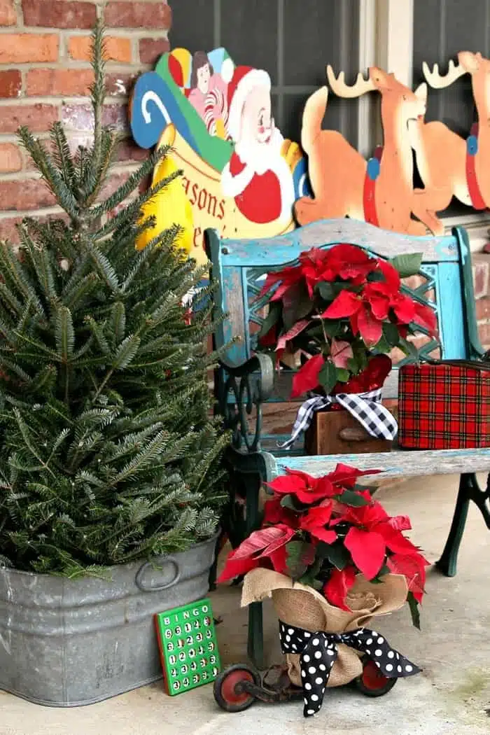 Christmas porch decorating with red poinsettias and vintage Christmas