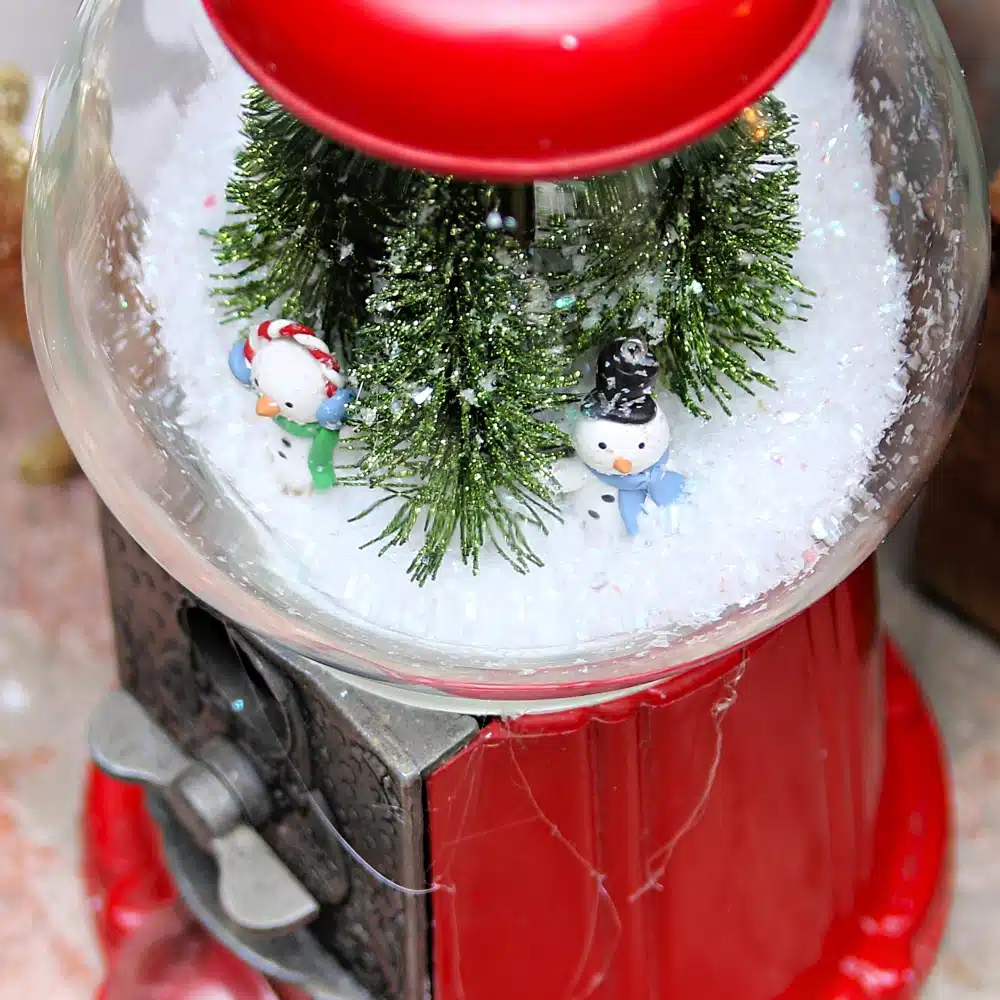 snow scene in a gumball machine globe