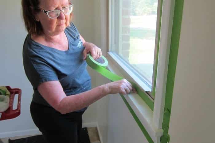 tape around windows with painters tape before painting