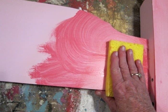 using a sponge to apply second color to furniture