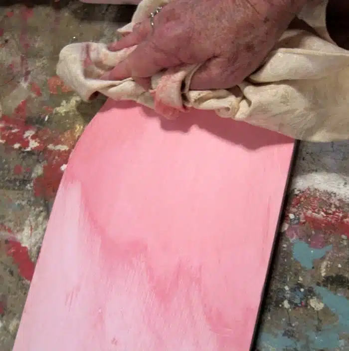 wiping excess paint with a rag