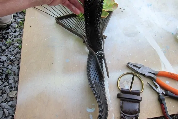 pull the belt through the top of the rake to make a hanger
