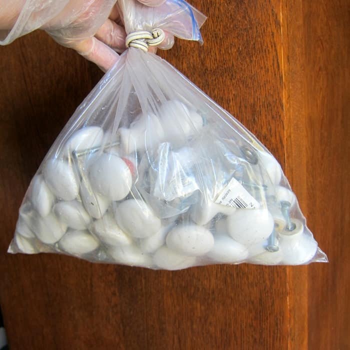 large lot of glossy white furniture cabinet knobs bought at auction