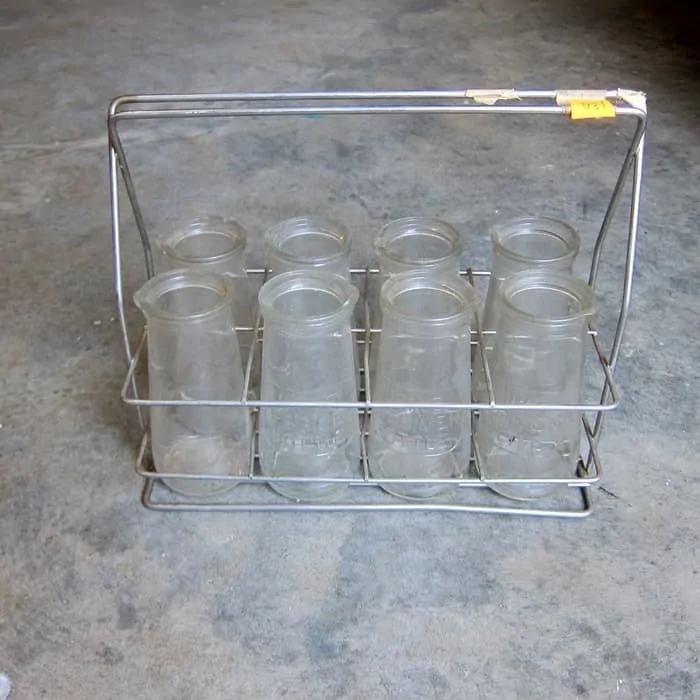 Vintage urine specimen bottles in metal carrier