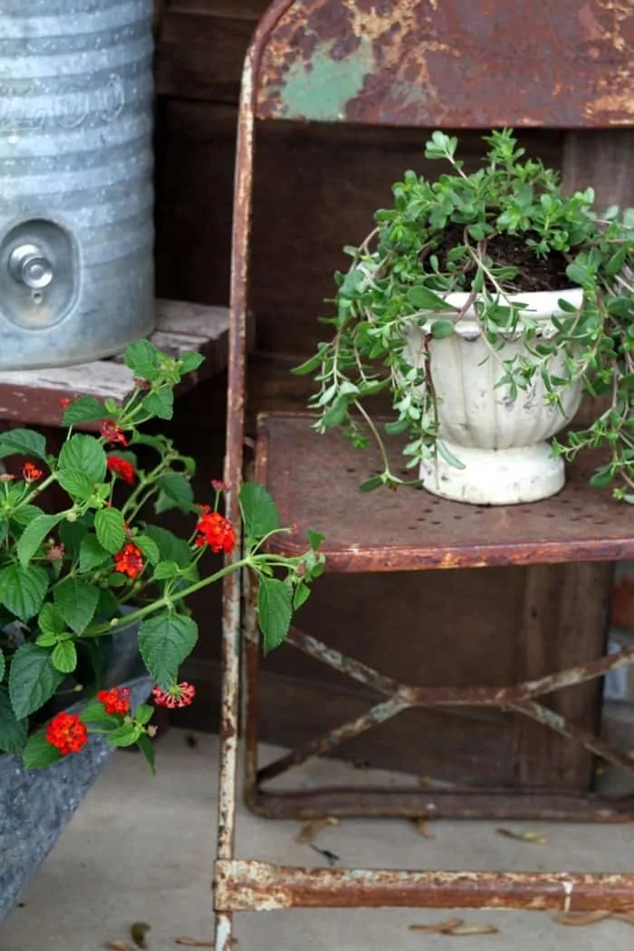 rusty pots and reclaimed chairs make great porch decorations