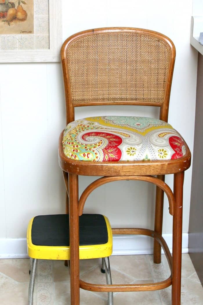 bar stool seat covered with old shower curtain