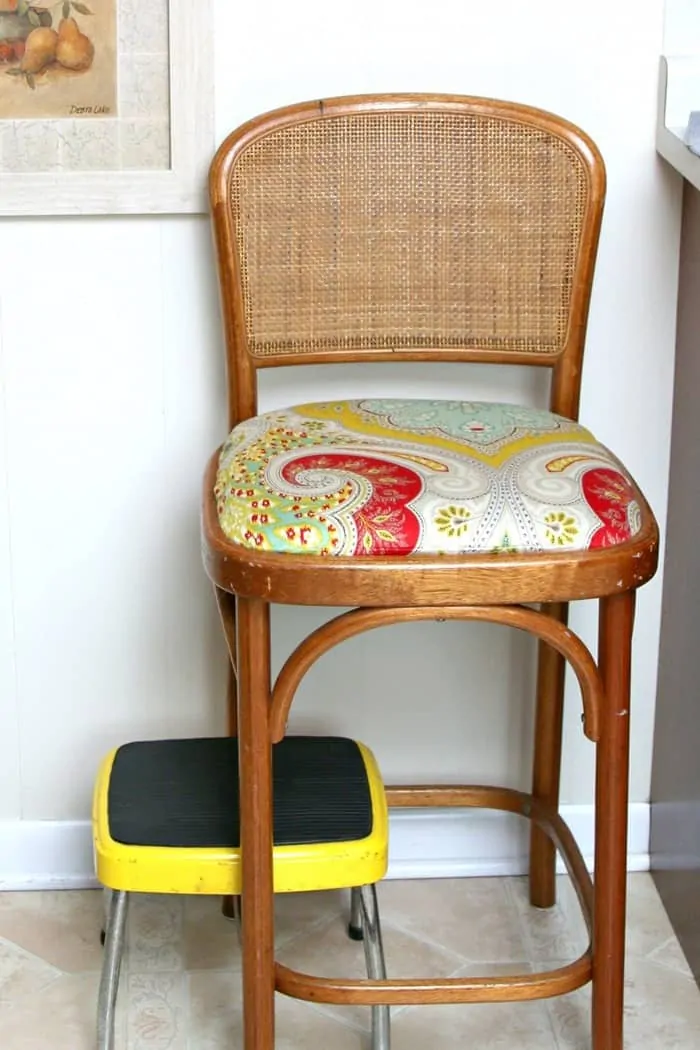 bar stool seat covered with old shower curtain