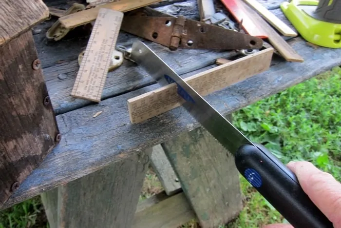 cutting a wood ruler to use in a junk project