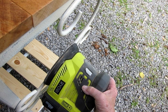 distressing painted metal with a power sander