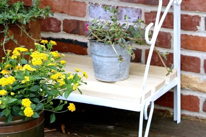 flower containers on a rustic plant stand