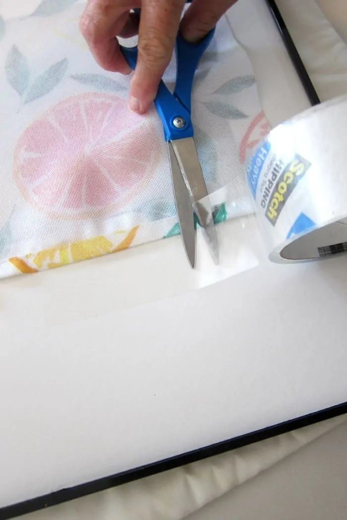 use clear packing tape to adhere print to photo mat