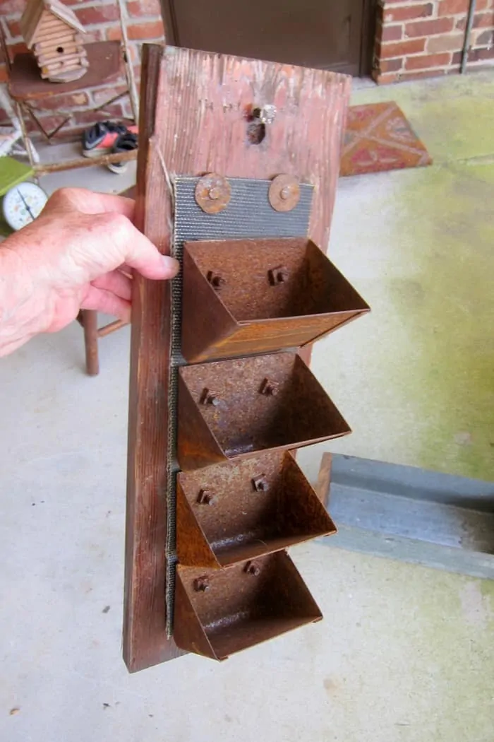 rusty bins on a wall hanging