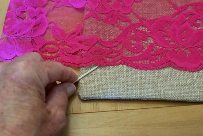 use hot glue to adhere lace and ribbon to crafts