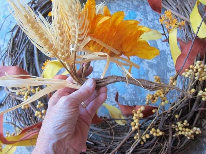 bend flower stem to go into grapevine wreath