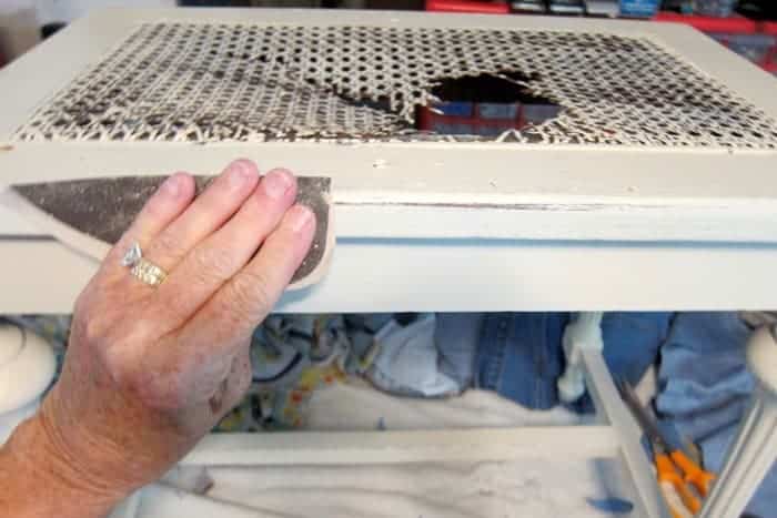 distress paint by hand with a piece of sandpaper