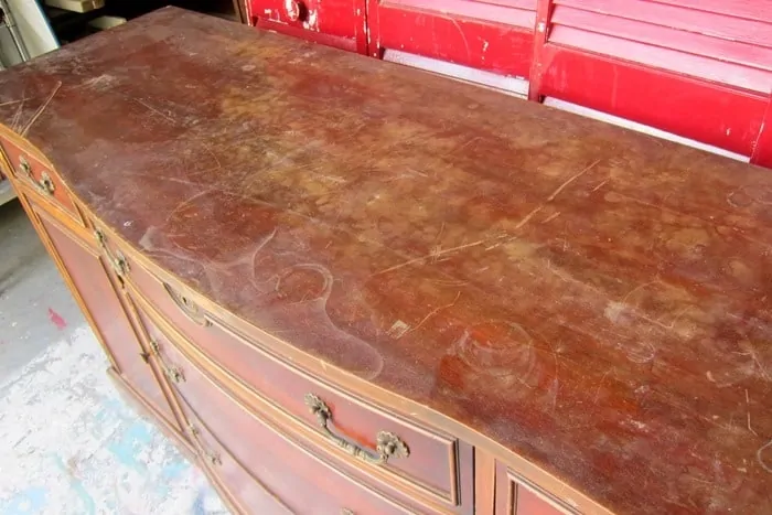furniture surface damaged with scratches and water marks