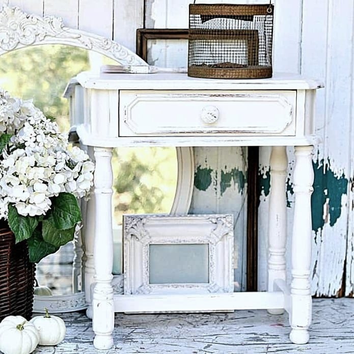 mirrors and picture frames spray painted white and distressed