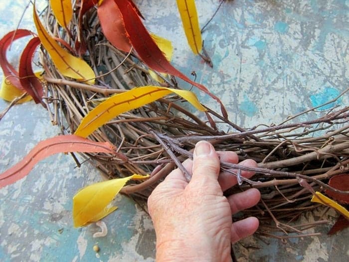 stick flower stems into grapevine wreath