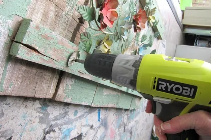 using a drill to attach metal to wood