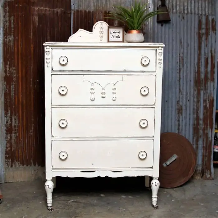 furniture makeover with distressed white paint and big wood knobs