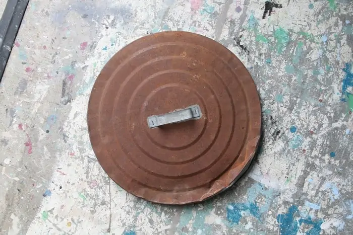 rusty garbage can lid