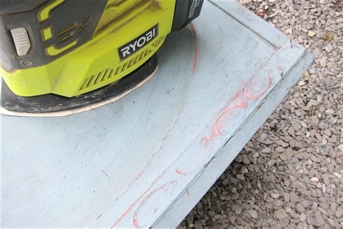 sanding paint with a battery sander