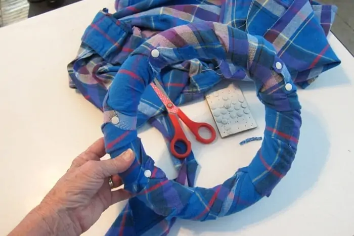 use small white tacks to adhere flannel fabric to wreath form