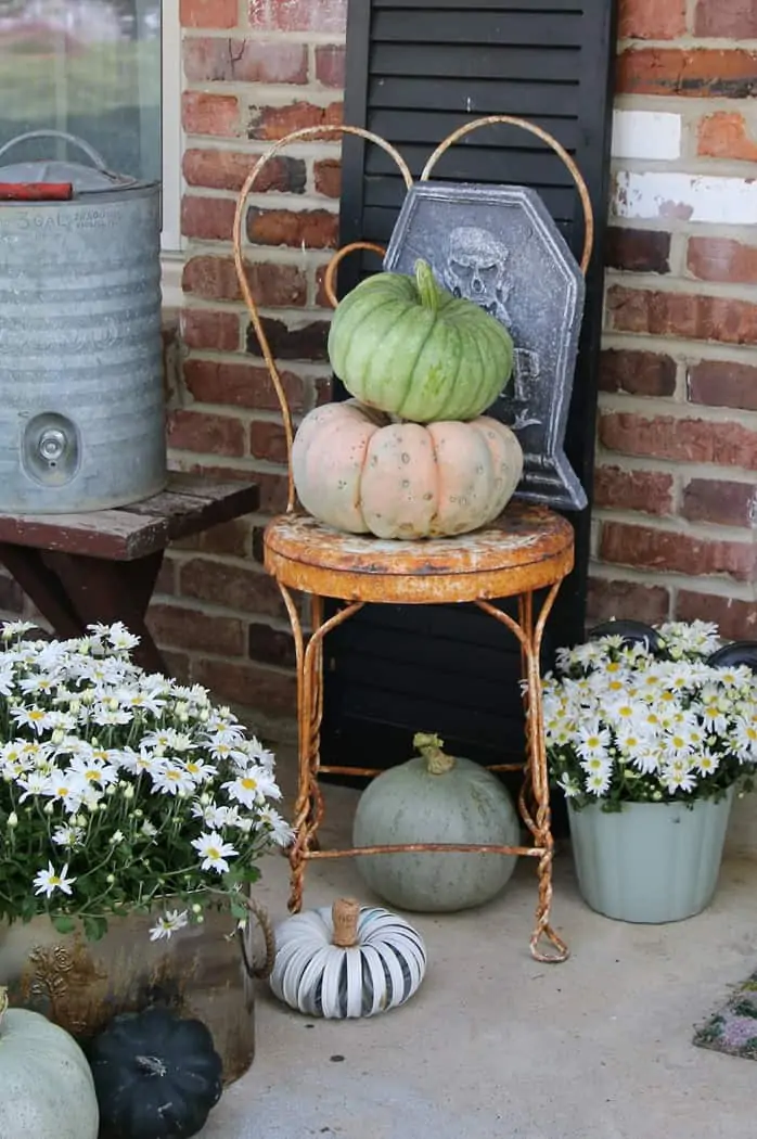 set pumpkins on vintage metal lawn chairs