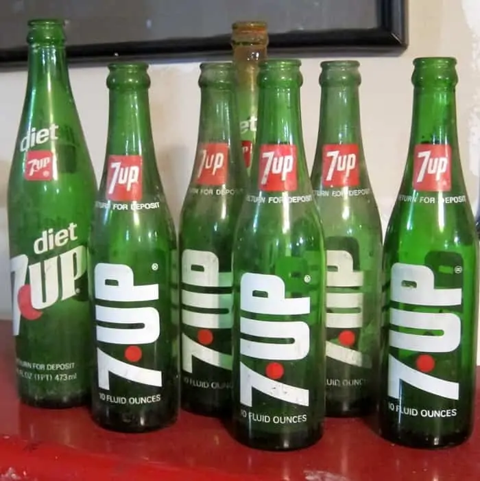 green 7UP bottles to use in Christmas decor by Petticoat Junktion