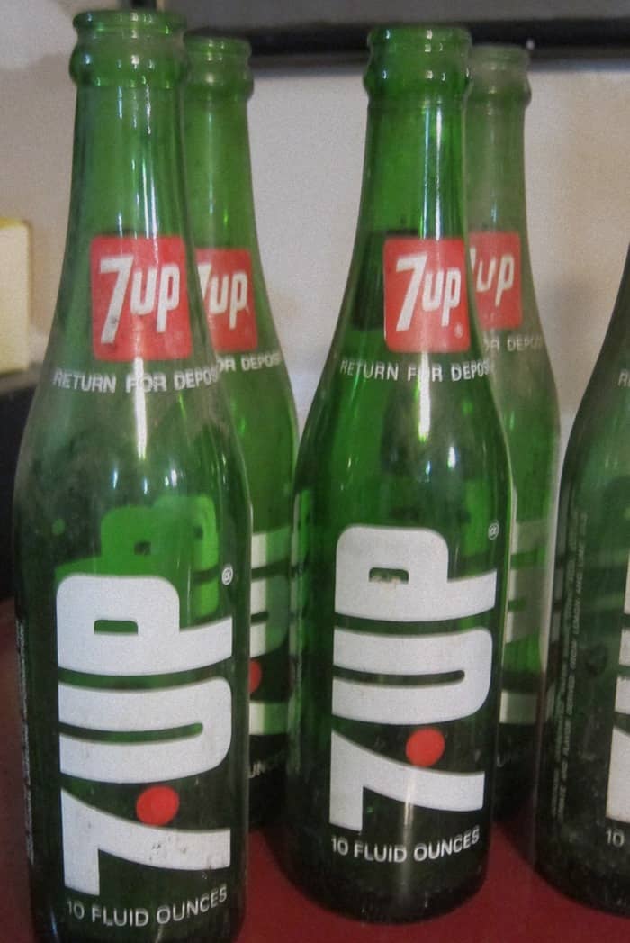 green 7UP bottles with pops of red for Christmas decorating