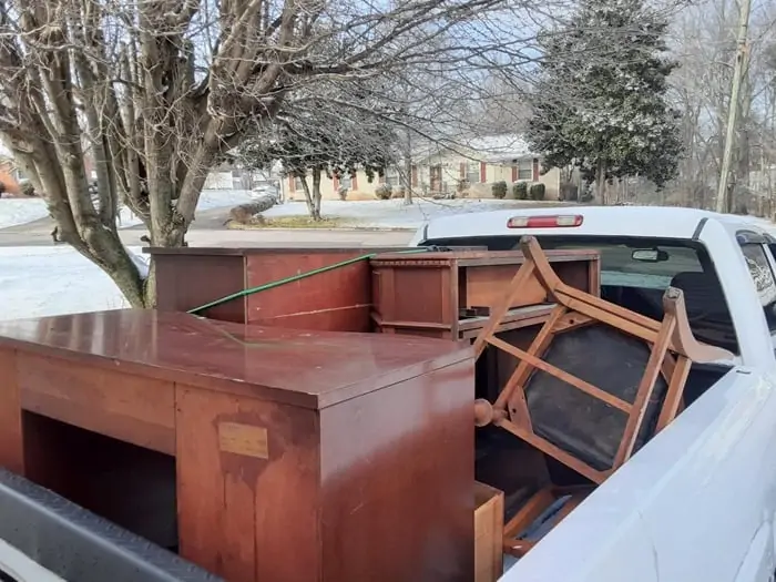 truckload of wood furniture bought at auction