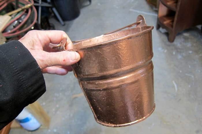 paint a flower pot or bucket with metallic spray paint