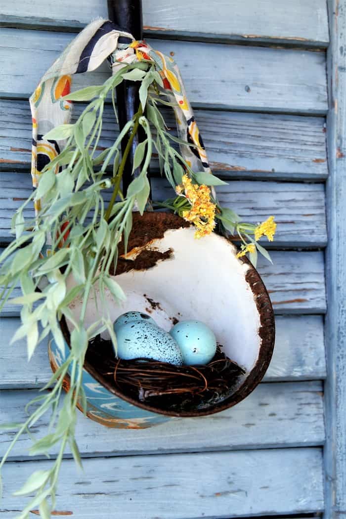 add greenery and a ribbon and hang a vintage water dipper holding a bird nest and eggs (2)