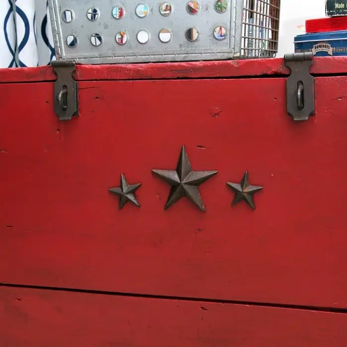 paint a wood chest red and decorate it with iron star nails