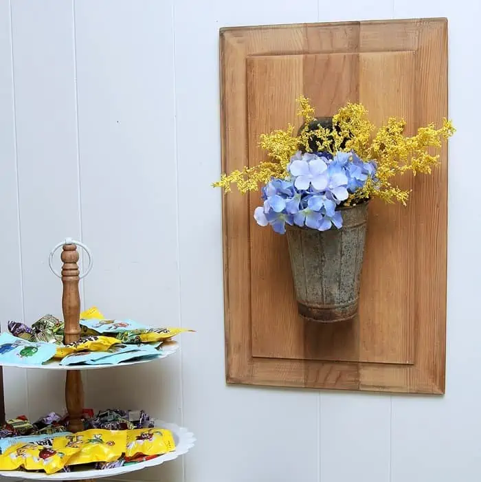 how to hang a bucket of flowers on a repurposed cabinet door
