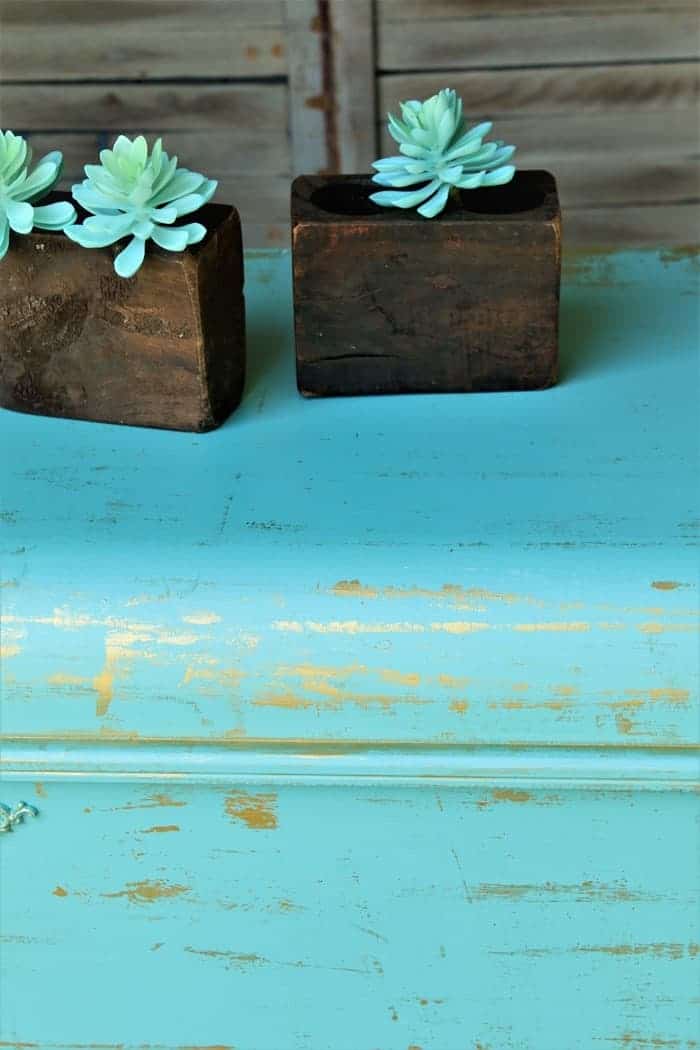 metallic accents on turquoise cedar chest