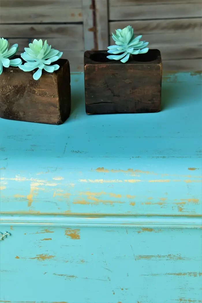 metallic accents on turquoise cedar chest