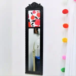Spray paint a framed mirror with black spray paint