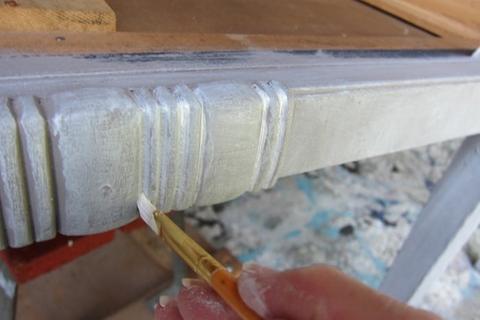 how to add white details to furniture using a small paint brush