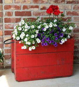 Upcycled Flower Pot Ideas using old metal toy trucks, rusty strainer, wood chests, a Christmas tree stand and more fun items.