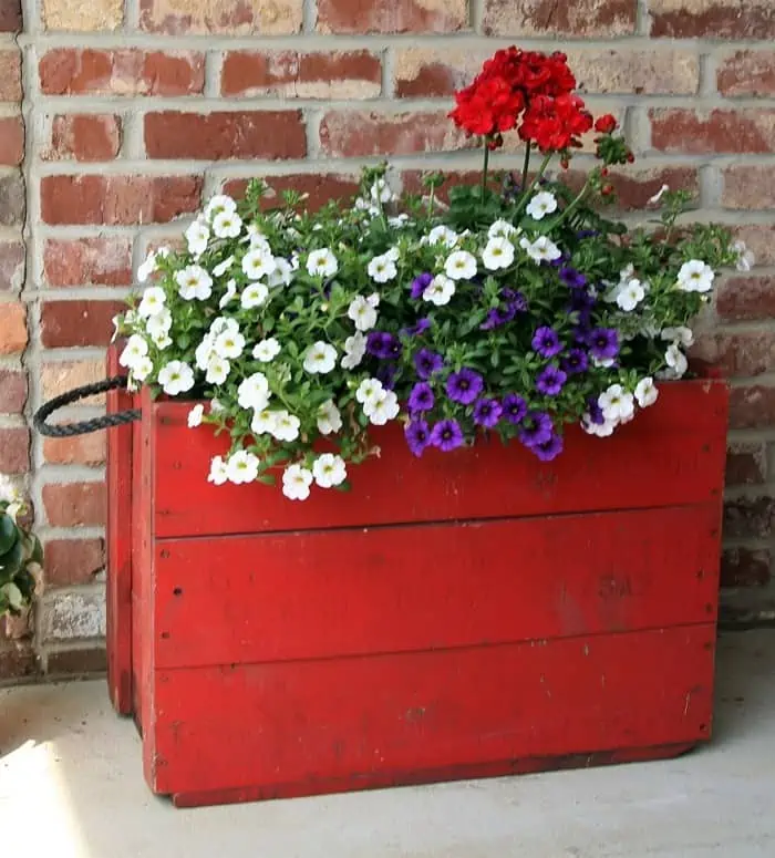 wood box painted red to use as a flower pot