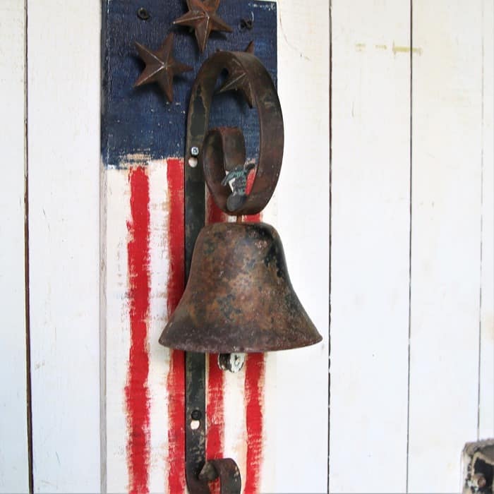 iron bell and rustic wood red white and blue flag diy